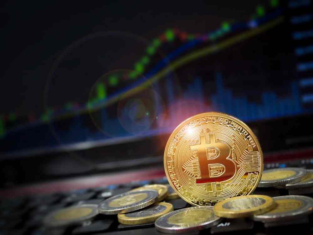 Tax on cryptocurrency - a bitcoin image against a trend report as background